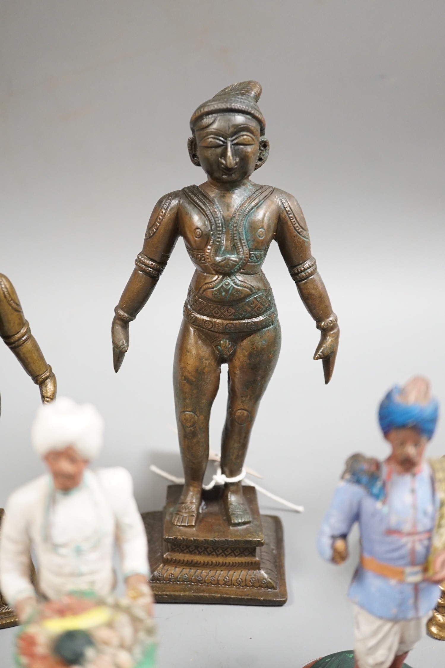 A group of Indian bronze figures of deities, tallest 20 cm and three Indian painted clay figures